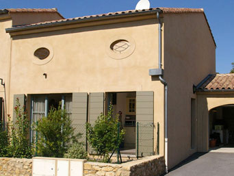 The front of the house with garage and parking on the right